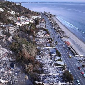 An aerial view shows the extent of the Palisades Fire on homes along the beach on Jan. 15 in Malibu.