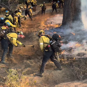 A crew suppresses flames from the Eaton Fire.