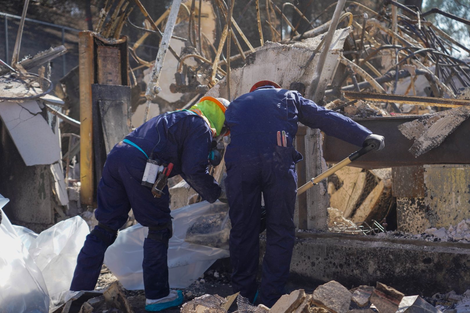 Workers clear fire debris.